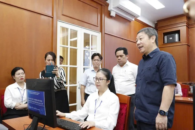 Bí thư Quận ủy quận 1 Dương Anh Đức theo dõi việc xử lý hồ sơ. (Ảnh: SGGP)